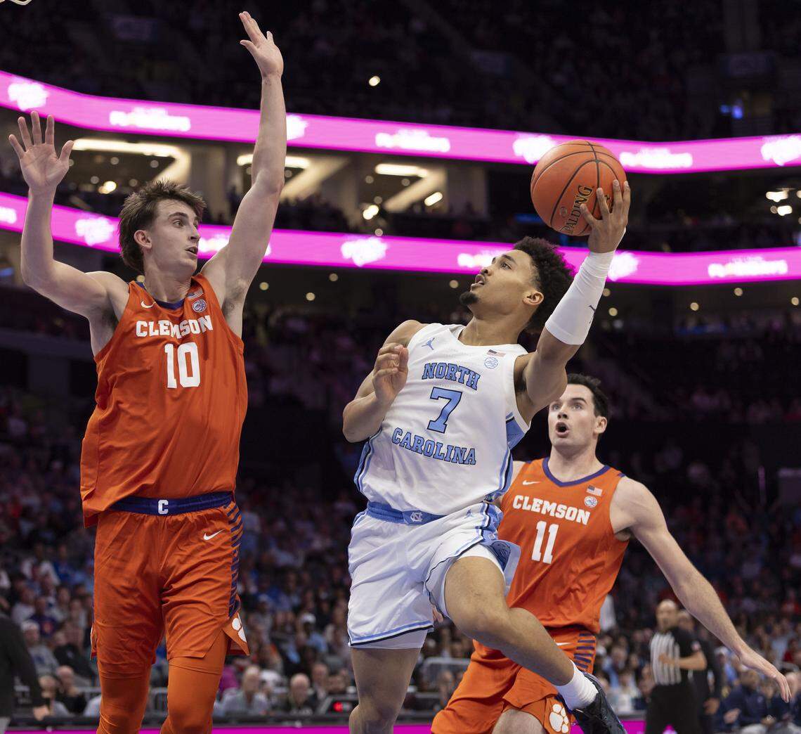 North Carolina guard Seth Trimble (7) drives to the basket against Clemson’s Jake Whalin (10) Nick Davidson (11) in the first half on Thursday, March 12, 2026, during the quarterfinals of the ACC Tournament at Spectrum Center in Charlotte,  N.C.