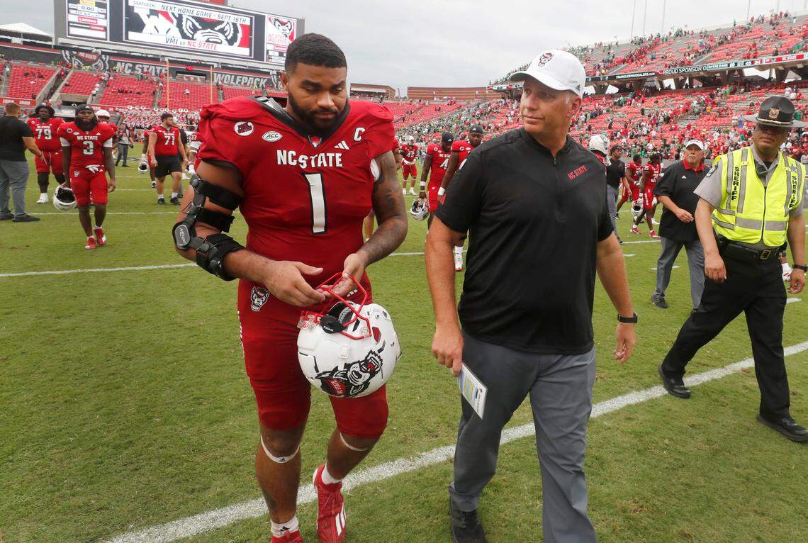 N.C. State head coach Dave Doeren walks off the field with defensive tackle Davin Vann (1) after Notre Dame’s 45-24 victory over N.C. State at Carter-Finley Stadium in Raleigh, N.C., Saturday, Sept. 9, 2023.
