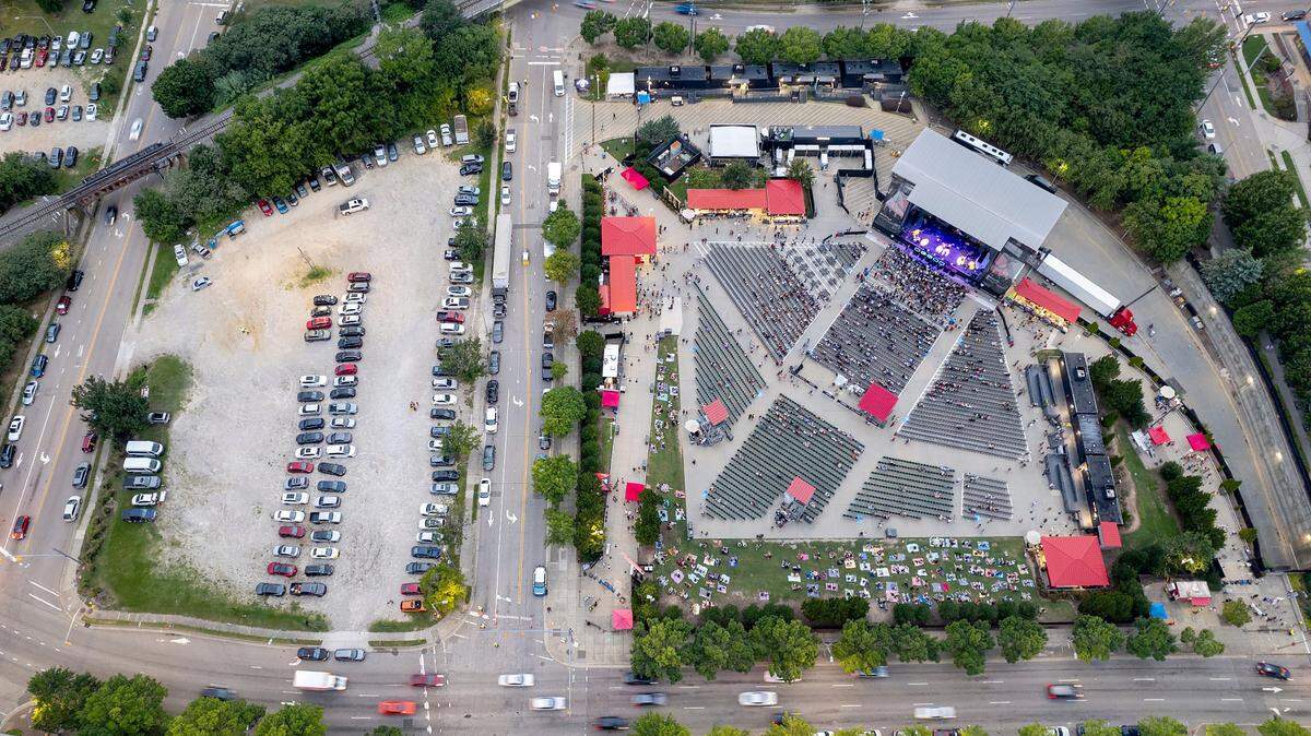 An aerial view of Red Hat Amphitheater, at right, with the intersection of South and McDowell Streets to the far left as seen prior to a concert on Tuesday, Aug. 13, 2024. A proposed plan to relocate Red Hat Amphitheater would permanently close a block of South Street to traffic.