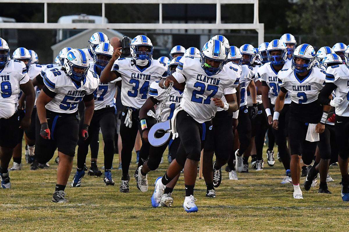 Clayton defensive lineman Kaden Blackwell (27) and his team rush onto the field before their game with Southeast Raleigh. The Southeast Raleigh Bulldogs and the Clayton Comets met in a non-conference football game in Raleigh, N.C. October 3, 2025