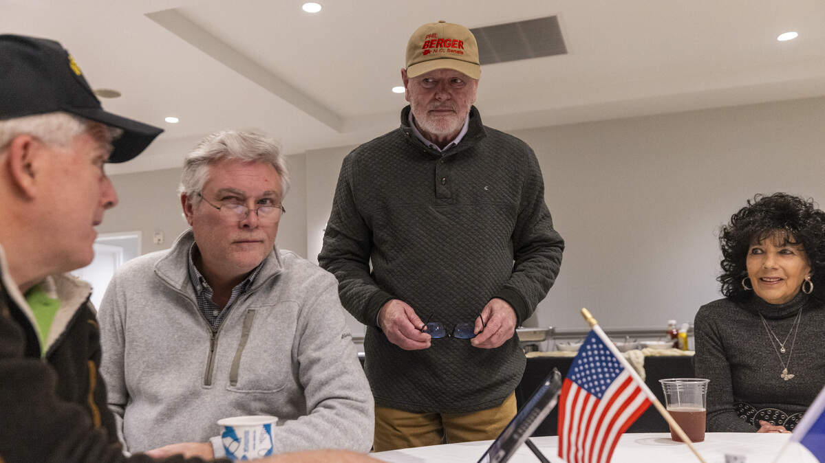 N.C. Sen. Phil Berger, an Eden Republican and the most powerful state lawmaker, center, checks early election results with supporters during a primary election night watch party in Reidsville, in Rockingham County on Tuesday, March 3, 2026. Berger is running against Rockingham County Sheriff Sam Page. The district also includes part of Guilford County.
