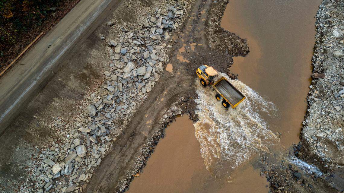 Large trucks like these are used to move rock from the Cane River to rebuild roads washed away by the remnants of Hurricane Helene.