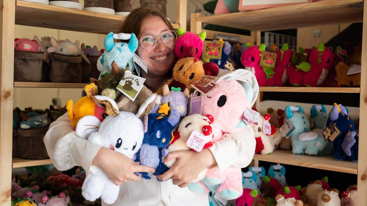 Emily Foster, owner of Alpaca Sews, holds a collection of plushies that she sells in her warehouse in Raleigh on Monday, July 22, 2024.