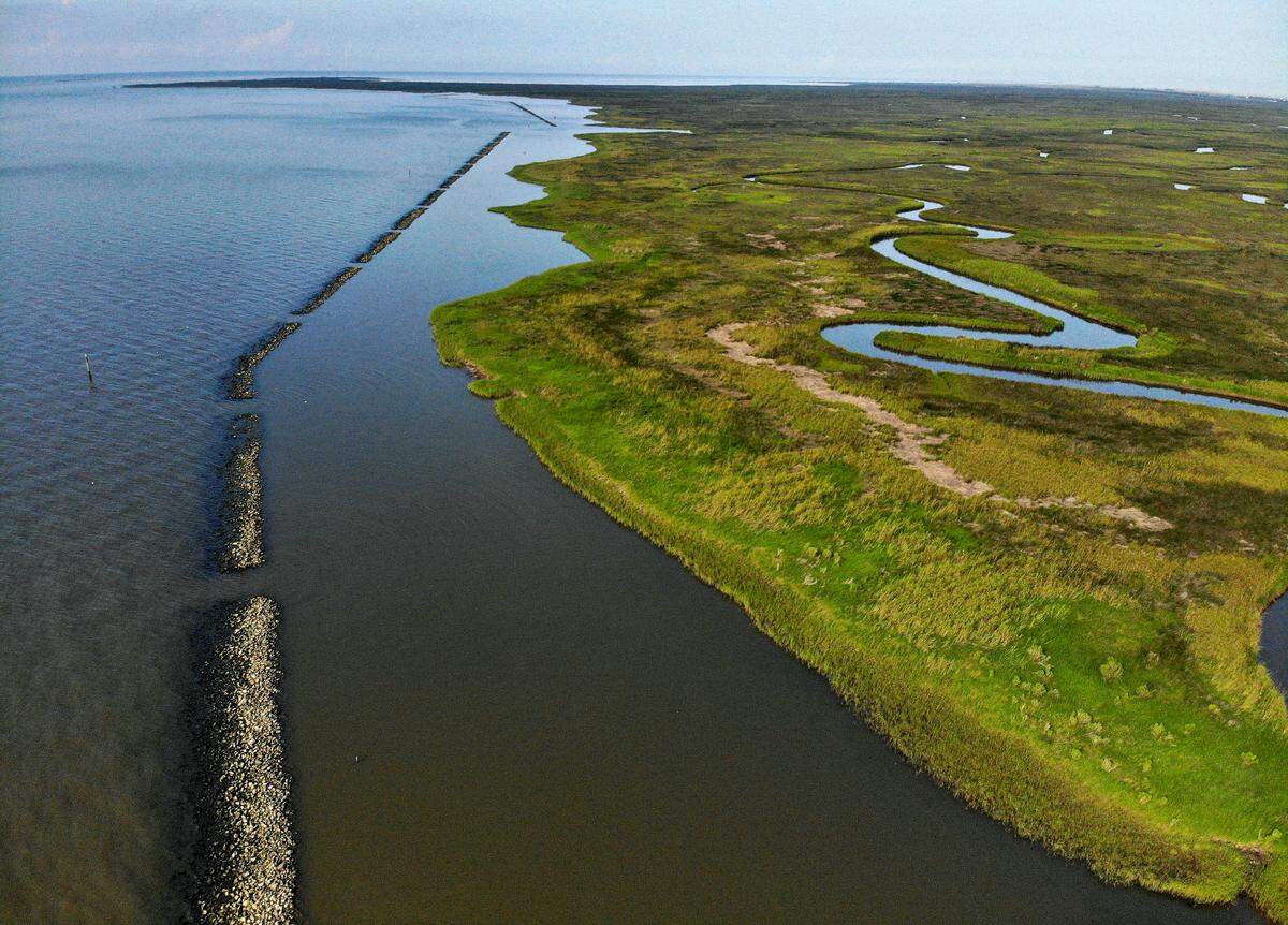 A section of breakwater, designed to reduce wave energy, protects six miles of living shoreline at Heron Bay in Hancock County. The breakwater and living shoreline are part of a $50 million project, funded by BP restoration money, to stabilize the erosion of the marsh.