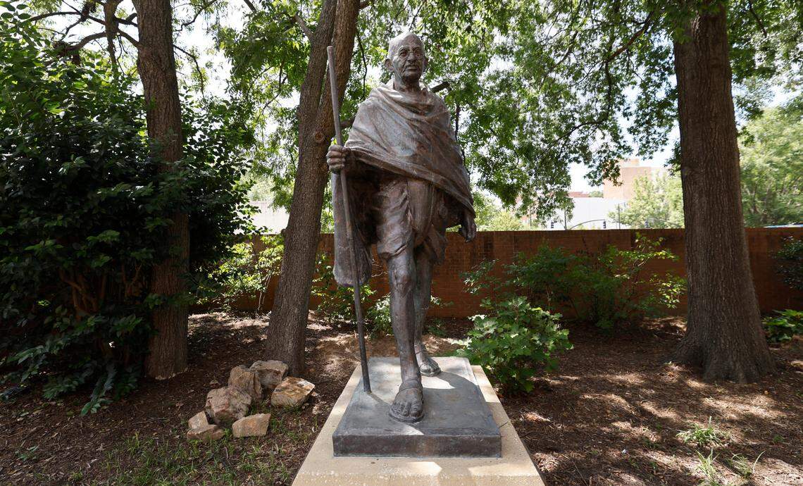A statue of Mohandas Gandhi stands outside the Marbles Kids Museum and IMAX theater. Photographed Wednesday, August 14, 2024.