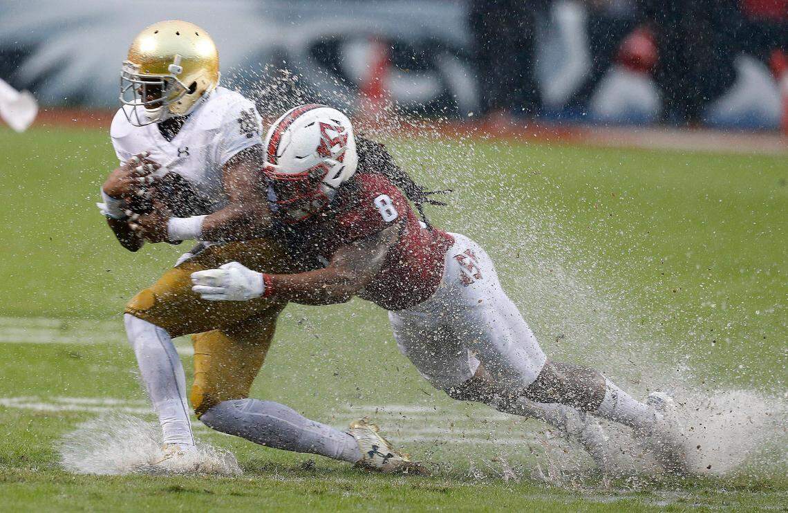N.C. State defensive back Dravious Wright (8) tackles Notre Dame wide receiver C.J. Sanders (3) during the first half of the Wolfpack’s game against Notre Dame at Carter-Finley Stadium in Raleigh, N.C., Saturday, Oct. 8, 2016.