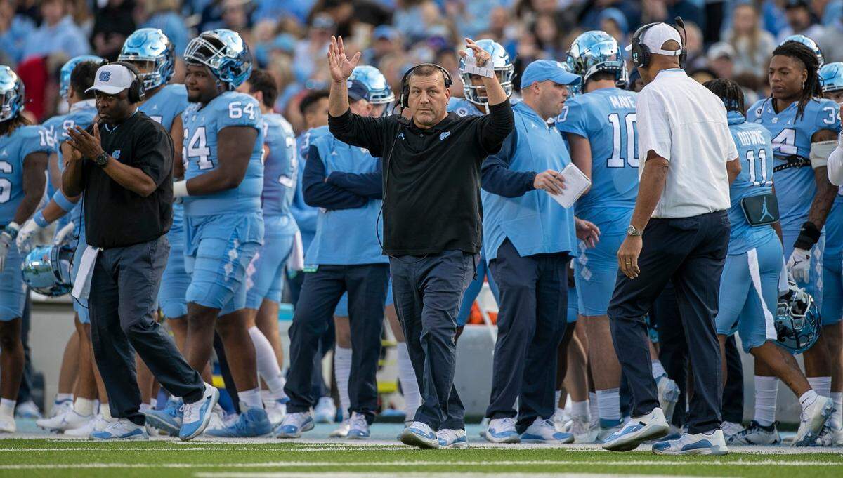 North Carolina offensive coordinator Phil Longo reacts after a 37-yard field goal by Noah Burnette in the first quarter against N.C. State on Friday, November 25, 2022 at Kenan Stadium in Chapel Hill, N.C.