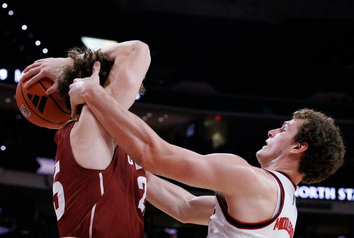Colgate’s Parker Jones grabs a rebound away from N.C. State’s Ben Middlebrooks during the first half of the Wolfpack’s 72-49 win at Lenovo Center on Monday, Nov. 18, 2024, in Raleigh, N.C.