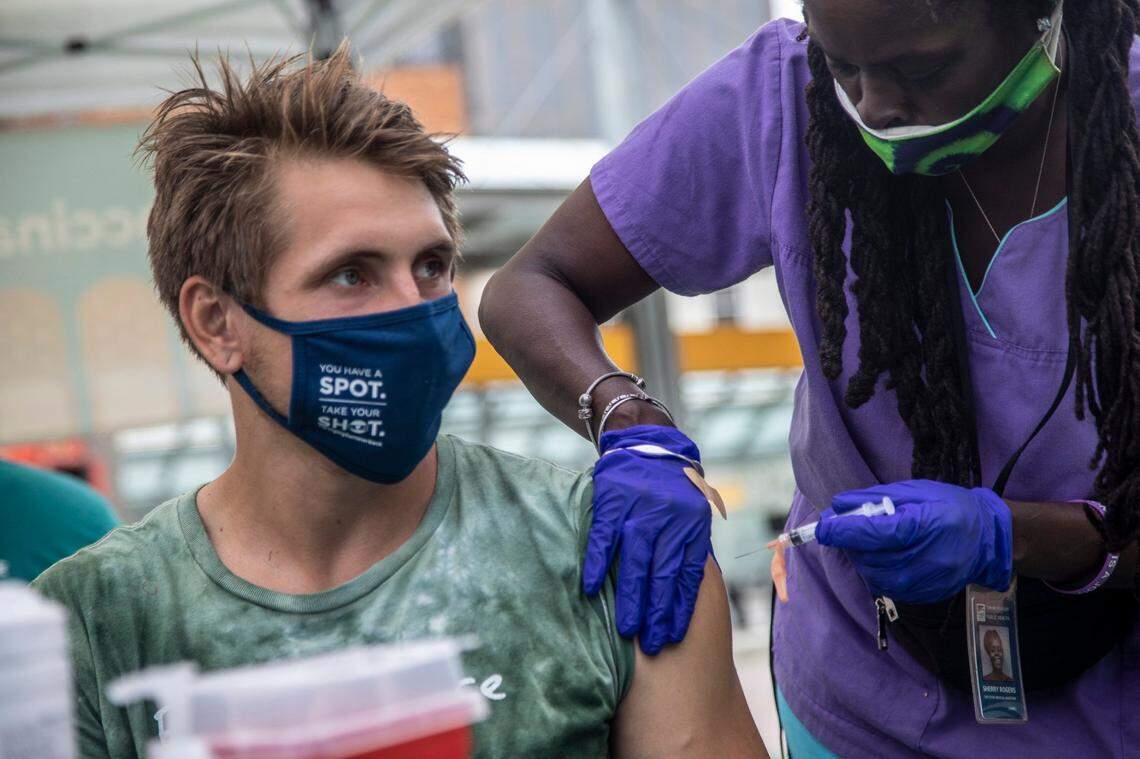 Medical Assistant Sherry Rogers administers a COVID-19 vaccine to Wesley Smith Tuesday, August 17, 2021 during a mobile vaccine clinic at the Go Raleigh bus station in downtown Raleigh.