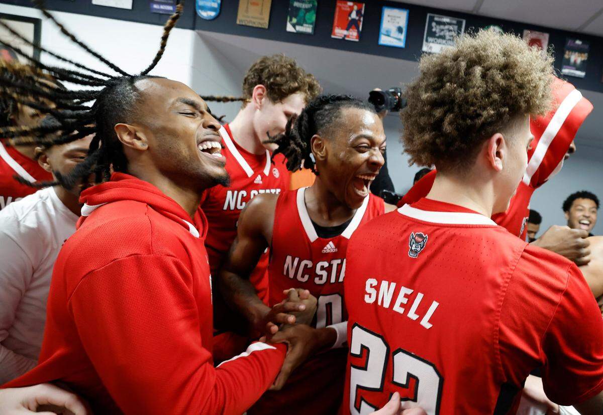 N.C. State’s Kam Woods, left, and DJ Horne celebrate heading to the locker room after the Wolfpack’s 72-65 overtime victory over Virginia in the semifinals of the 2024 ACC Men’s Basketball Tournament at Capital One Arena in Washington, D.C., Friday, March 15, 2024.