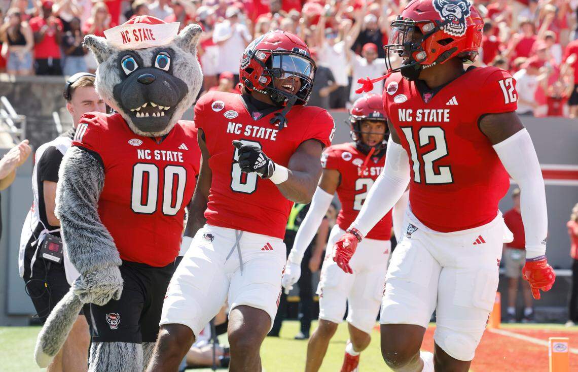 N.C. State defensive back Robert Kennedy (8) celebrates with Devan Boykin (12) after returning an interception for a touchdown during the first half of N.C. State’s game against VMI at Carter-Finley Stadium in Raleigh, N.C., Saturday, Sept. 16, 2023.