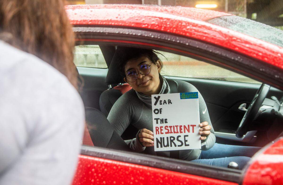 Jessica Hernandez, 26, will be working as an ICU nurse at Central Harnett Hospital in Lillington holds up a sign during a drive-through pinning ceremony for the Wake Tech Community College Martha Mann Smith School of Nursing graduates Monday morning, April 20, 2020. Sixty four nursing students graduated program with nursing degrees Monday.