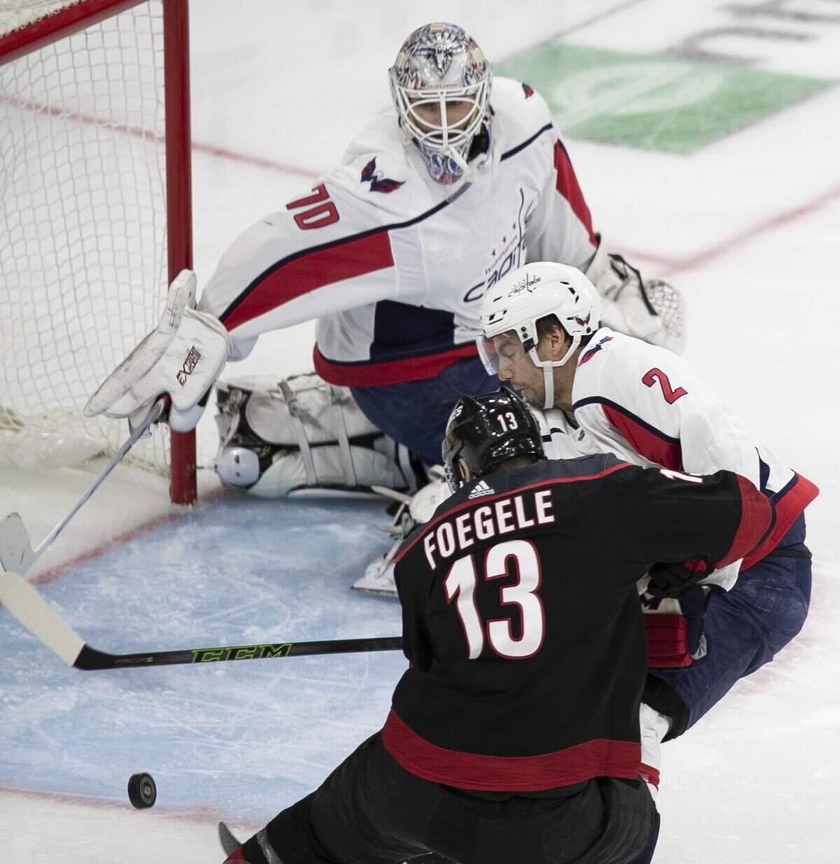 Carolina Hurricanes’ Warren Foegele (13) scores on Washington Capitals’ goalie Braden Holtby (70) during the first period in game four of the first round Stanley Cup series game on Thursday, April 18, 2019 at the PNC Arena in Raleigh, N.C.
