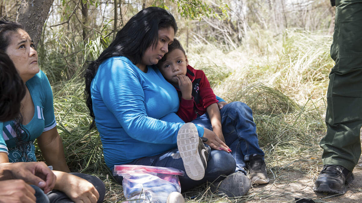 Keilyn Enamorada Matute, from Honduras, with her 4-year old son, as they surrender themselves to Border Patrol agents after crossing the Rio Grande from Mexico to the United States, in McAllen, Texas, June 8, 2018. The Trump administration said on June 15, that it had separated 1,995 children from parents facing criminal prosecution for unlawfully crossing the border over a six-week period that ended last month, as President Donald Trump sought to shift blame for the practice that has become the signature policy of his immigration agenda.