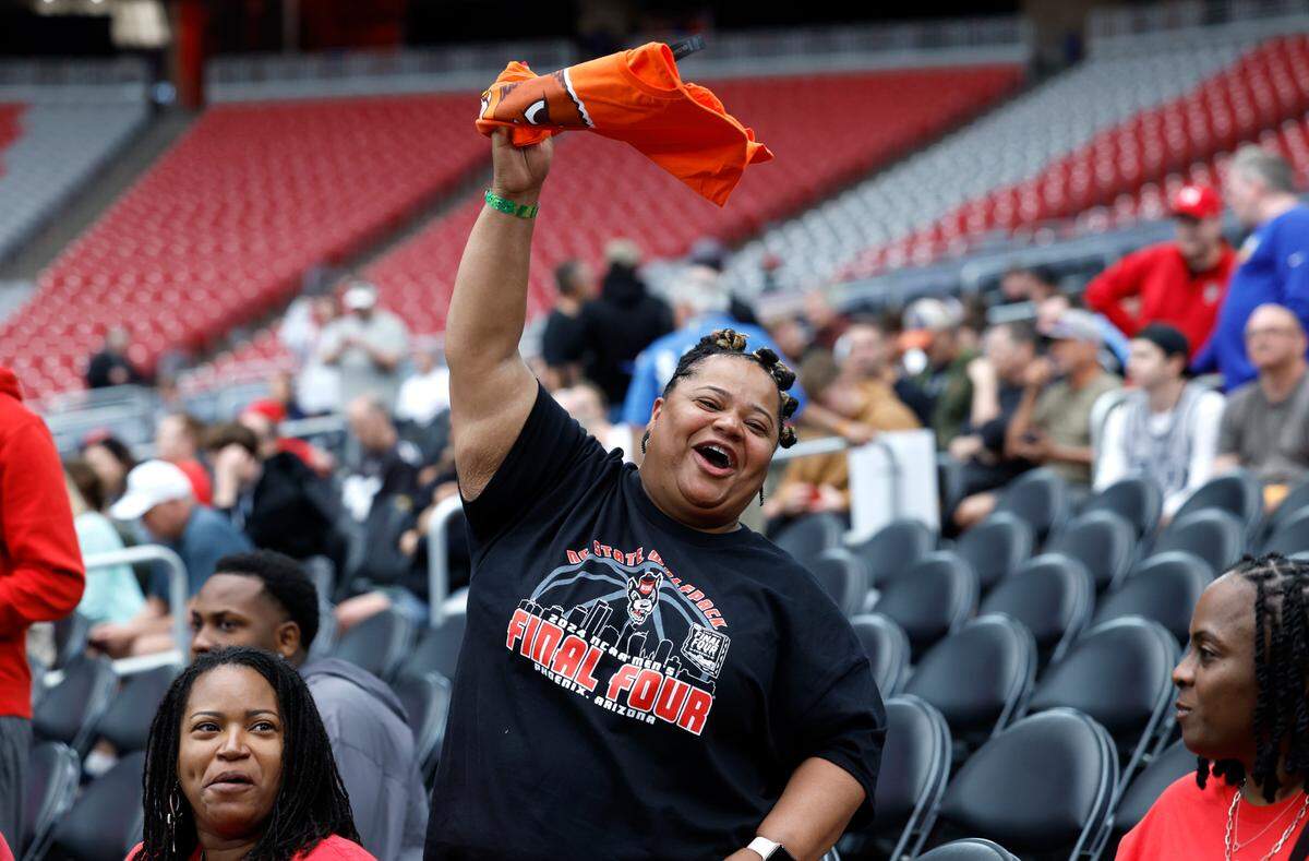 Kimberly Wilson of Raleigh, aunt of N.C. State’s DJ Horne, cheers on the team during the Wolfpack’s practice at State Farm Stadium in Glendale, Ariz., Friday, April 5, 2024. The Wolfpack will face Purdue in the NCAA Tournament national semifinals Saturday.