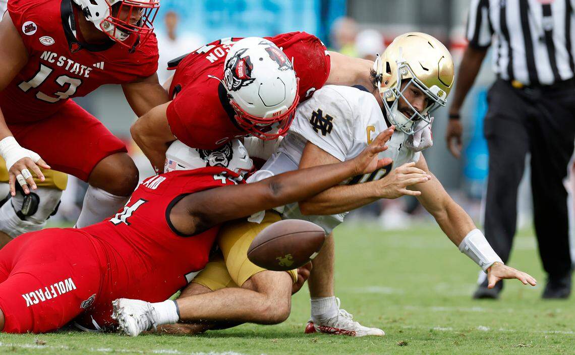 N.C. State’s Brandon Cleveland (44) andPayton Wilson (11) sack Notre Dame quarterback Sam Hartman (10) causing him to fumble during the second half of Notre Dame’s 45-24 victory over N.C. State at Carter-Finley Stadium in Raleigh, N.C., Saturday, Sept. 9, 2023.