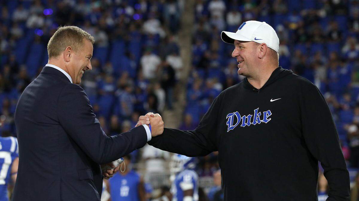 Duke head coach Mike Elko greets ESPN’s Kirk Herbstreit prior to the Blue Devils’ game against Notre Dame at Wallace Wade Stadium on Saturday, Sept. 30, 2023, in Durham, N.C.