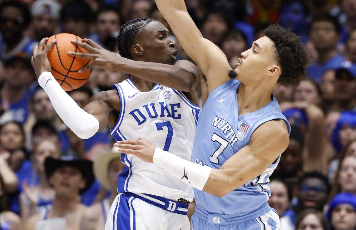 North Carolina's Seth Trimble (7) defends Duke’s Dame Sarr (7) during the first half of Duke’s game against UNC at Cameron Indoor Stadium in Durham, N.C., Saturday, March 7, 2026.