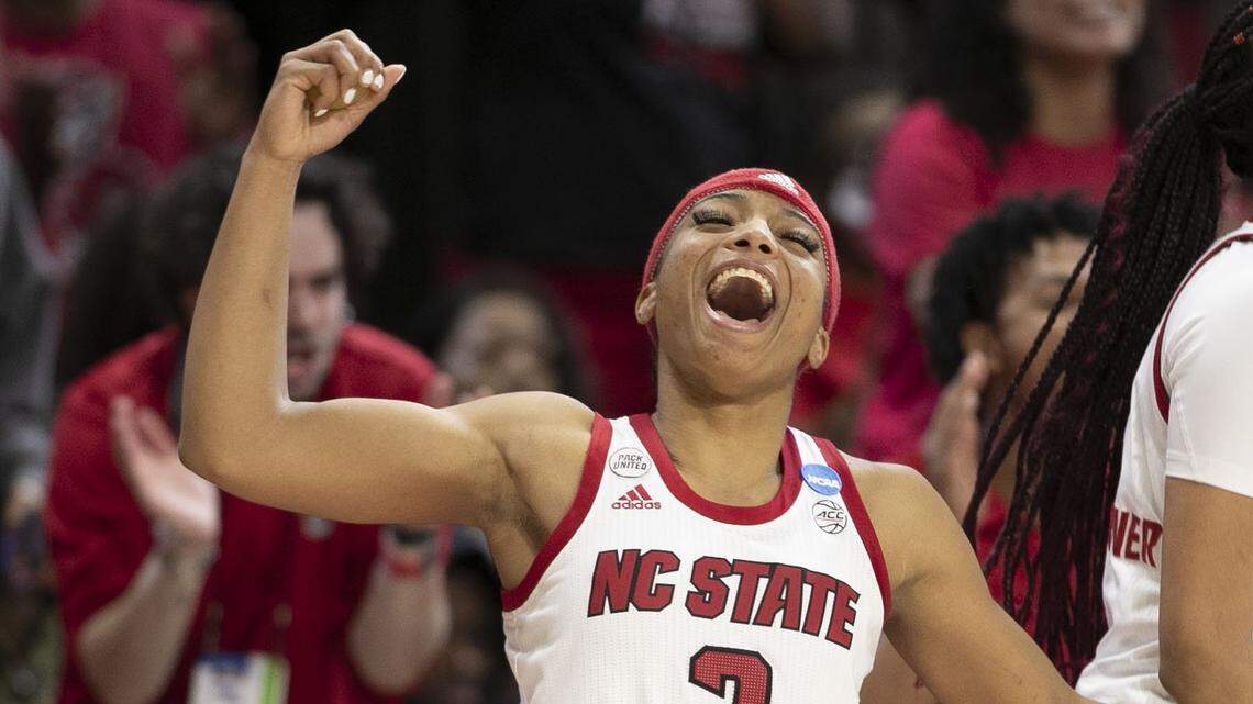 N.C. States Kai Crutchfield (3) and Jakia Brown-Turner (11) react after a basket by Sophie Hart (32) to secure an 89-57 victory over Kansas State during the second round of the NCAA Tournament on Monday, March 21, 2022 at Reynolds Coliseum in Raleigh, N.C.