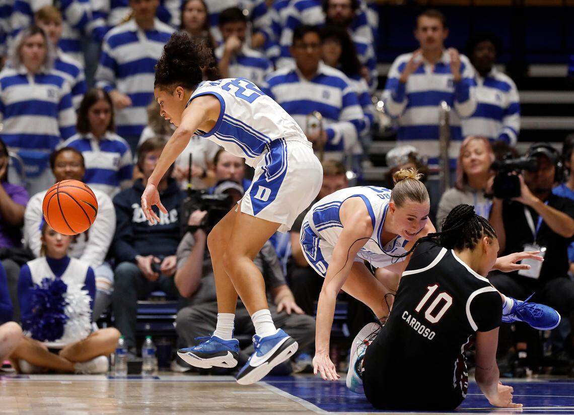 Duke’s Camilla Emsbo and South Carolina’s Kamilla Cardoso collide as Duke’s Taina Mair, left, chases after a loose ball during the second half of the Blue Devils’ 77-61 loss on Sunday, Dec. 3, 2023, at Cameron Indoor Stadium in Durham, N.C.