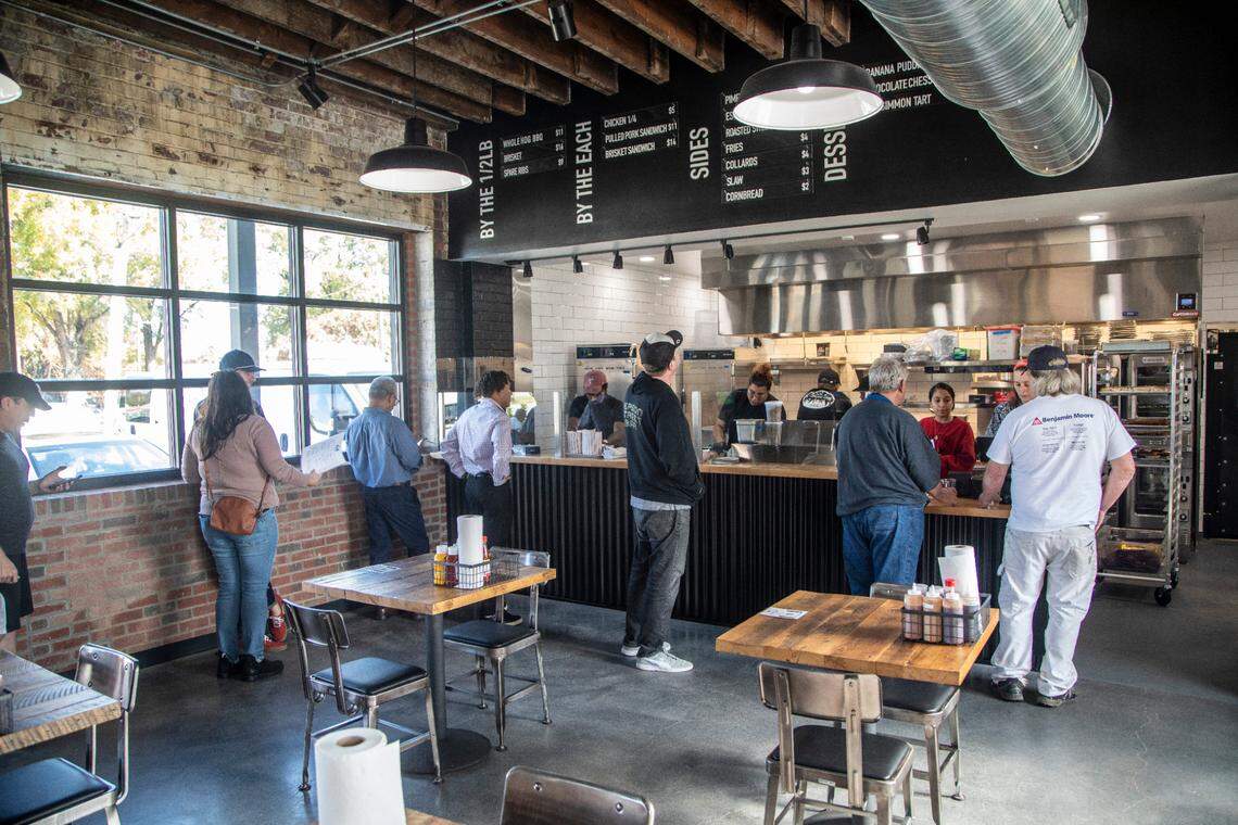Customers place orders during the opening of Longleaf Swine in Raleigh Friday, Nov. 4, 2022.