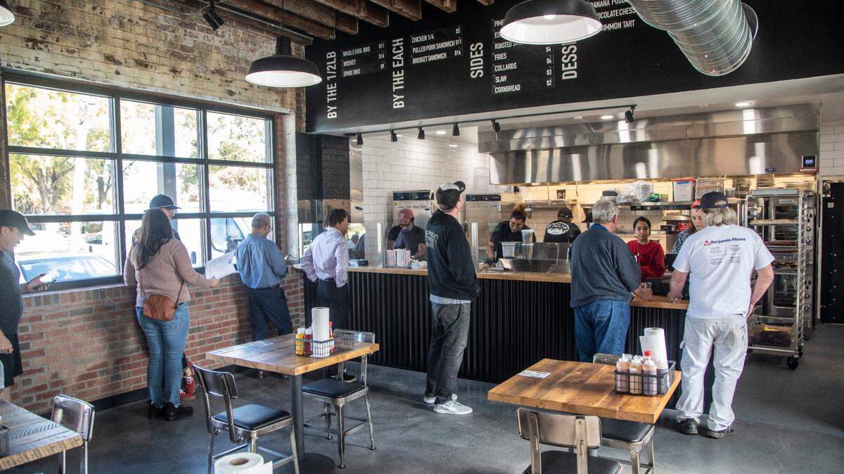 Customers place orders during the opening of Longleaf Swine in Raleigh Friday, Nov. 4, 2022.