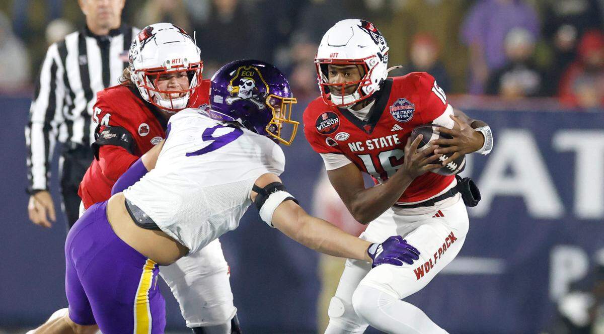 East Carolina defensive lineman J.D. Lampley (9) sacks N.C. State quarterback CJ Bailey (16) during the first half of N.C. State’s game against ECU in the Military Bowl at Navy-Marine Corps Memorial Stadium in Annapolis, Md., Saturday, Dec. 28, 2024.