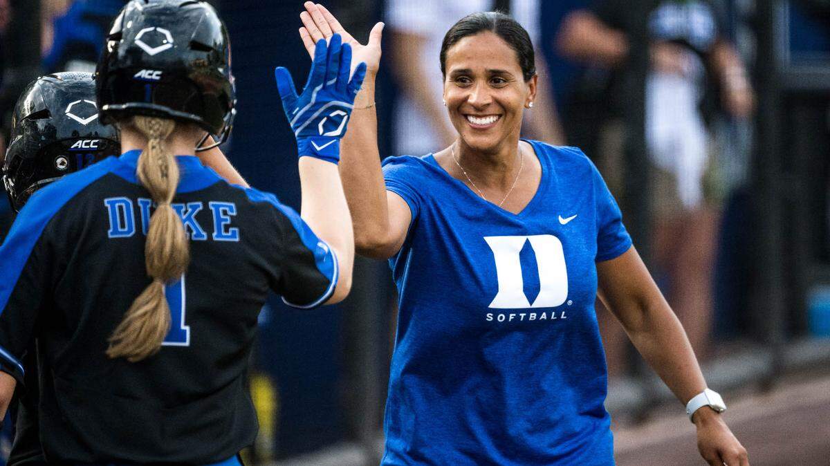 Duke softball coach Marissa Young (right) high-fives Blue Devils outfielder Caroline Jacobsen during Duke’s 13-5 win over Georgia in the NCAA regional championship at Durham on May 22, 2022.