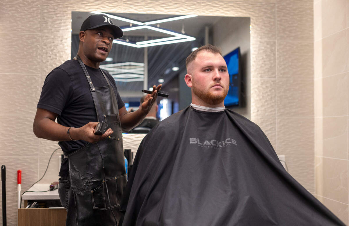 Barber Lionel Poteat talks with North Carolina offensive lineman Zach Greenberg at the team’s barber shop on Tuesday, September 10, 2024 at Kenan Stadium in Chapel Hill, N.C.