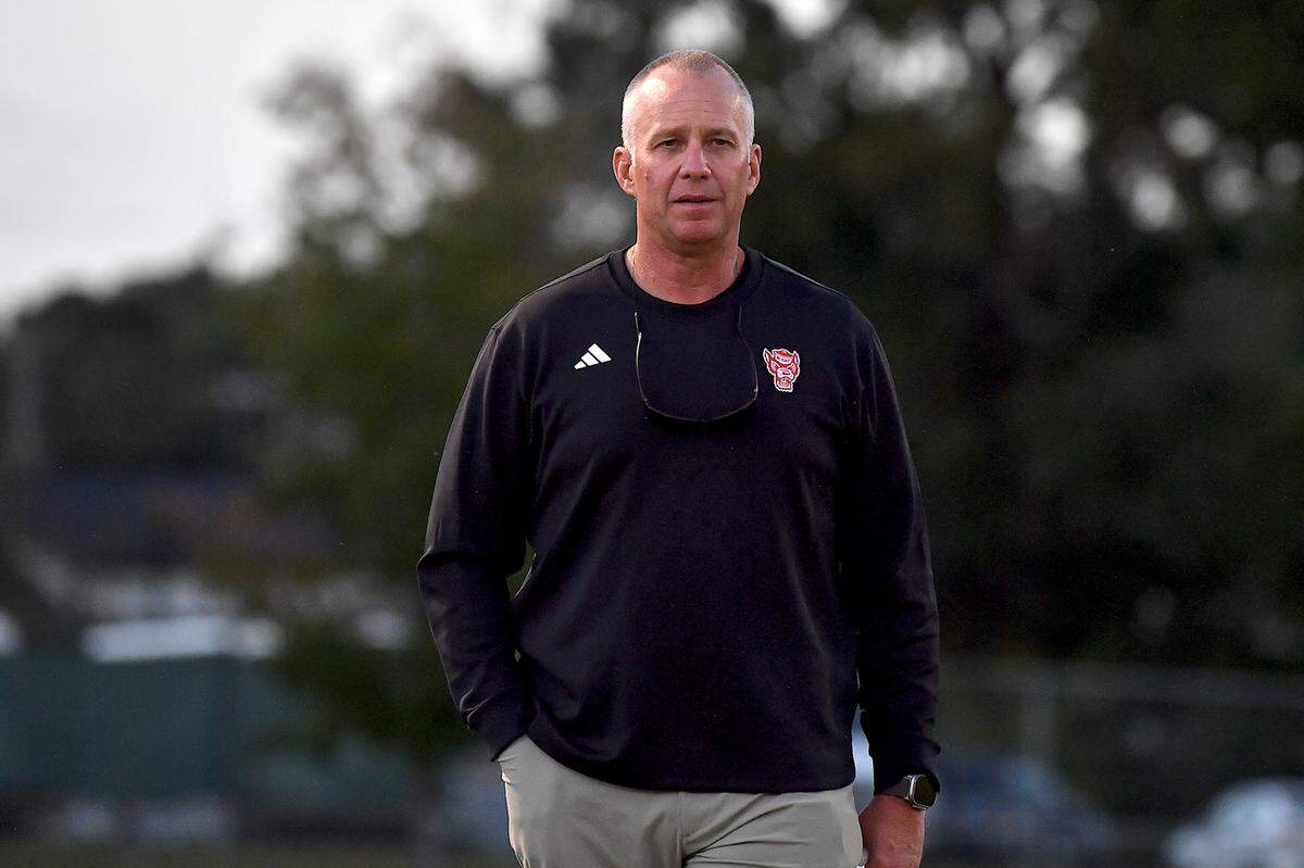 N.C. State head football coach Dave Doeren on the sidelines checking the pregame drills of Southeast Raleigh and Clayton. The Southeast Raleigh Bulldogs and the Clayton Comets met in a non-conference football game in Raleigh, N.C. October 3, 2025