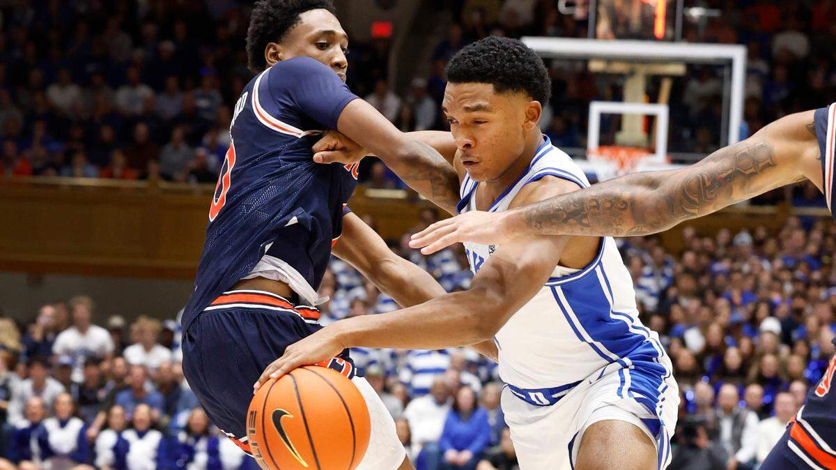 Duke’s Caleb Foster (1) drives by Auburn’s Tahaad Pettiford (0) during the second half of Duke’s 84-78 victory over Auburn at Cameron Indoor Stadium in Durham, N.C., Wednesday, Dec. 4, 2024.