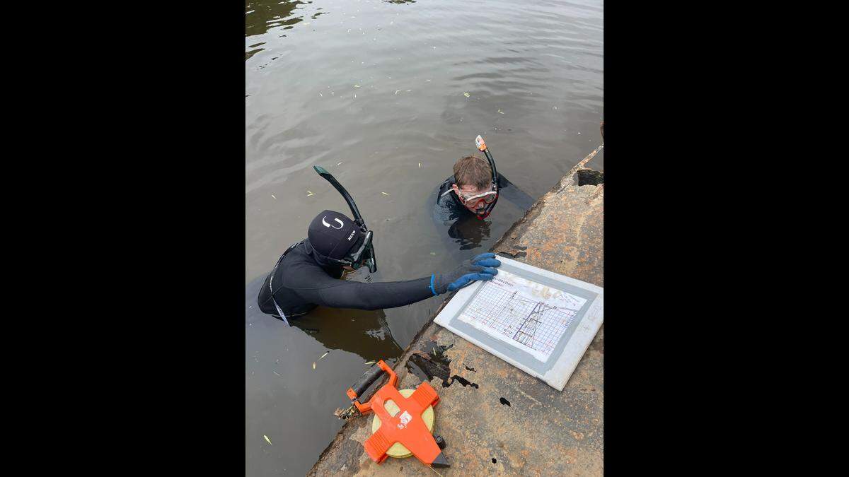 Jacob Thomas and Liam O’Brien record shallow water section of the starboard-side plating of PC-1084 near Fayetteville.