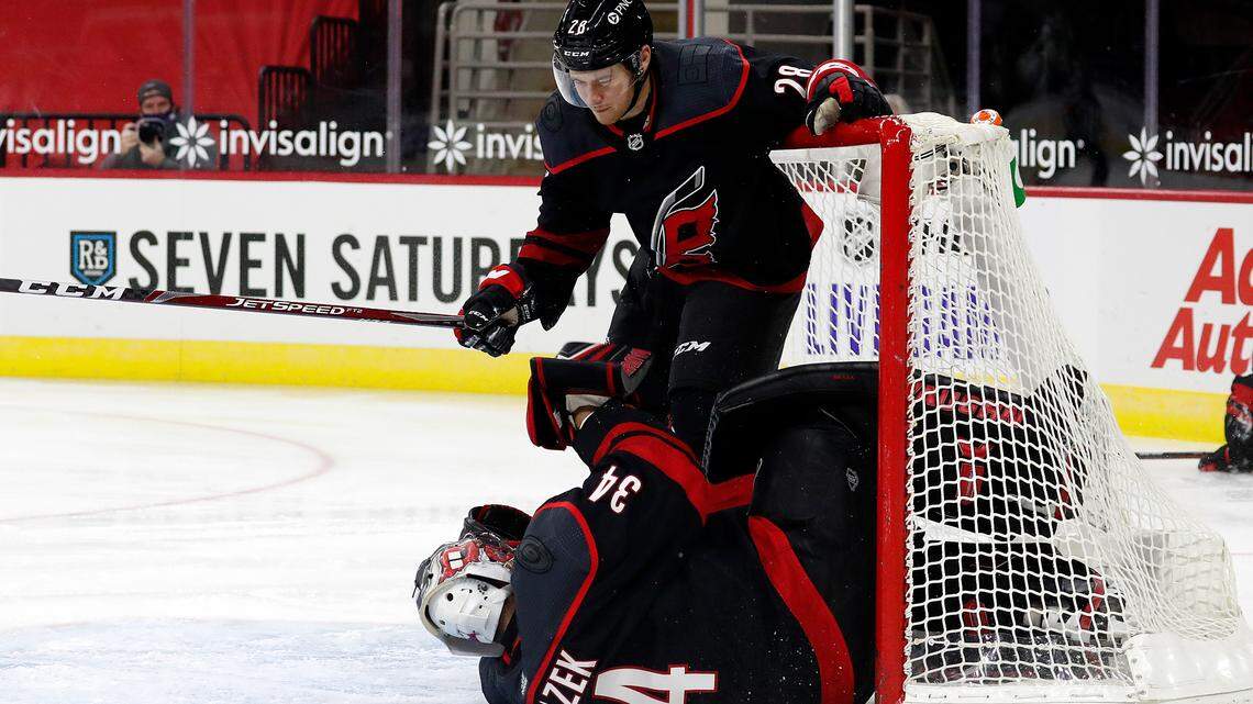 Carolina Hurricanes’ Max McCormick (28) collides with goaltender Petr Mrazek (34) causing and injury to Mrazek during the first period of an NHL hockey game against the Dallas Stars in Raleigh, N.C., Saturday, Jan. 30, 2021. (AP Photo/Karl B DeBlaker)