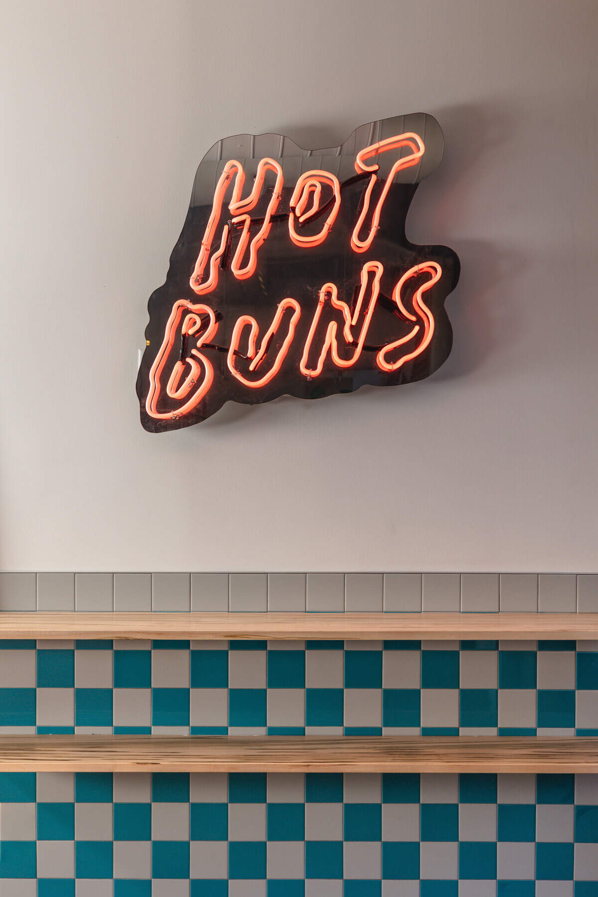 So true they put it in neon: you can find hot buns at the new Lutra Cafe & Bakery.
