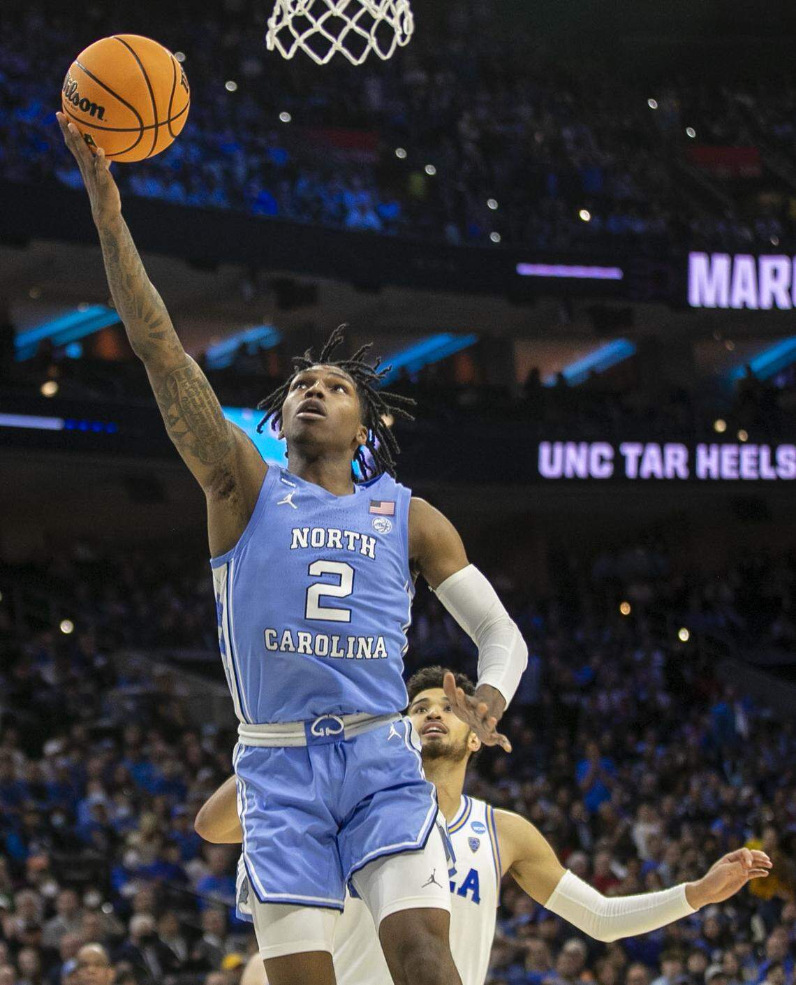 North Carolina’s Caleb Love (2) breaks to the basket against UCLA’s Johnny Juzang (3) in the second half on Friday, March 25, 2022 during the NCAA East Regional semi-final at Wells Fargo Center in Philadelphia, Pa.