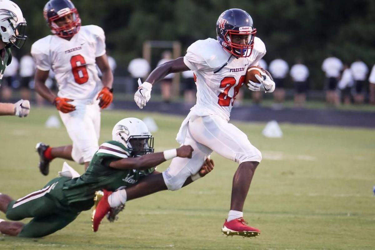 Southern Nash running back Zonovan Knight (28) outruns the tackle attempt of Green Hope defender Chuck Hills (3) during the Southern Nash game at Green Hope in August 2017.