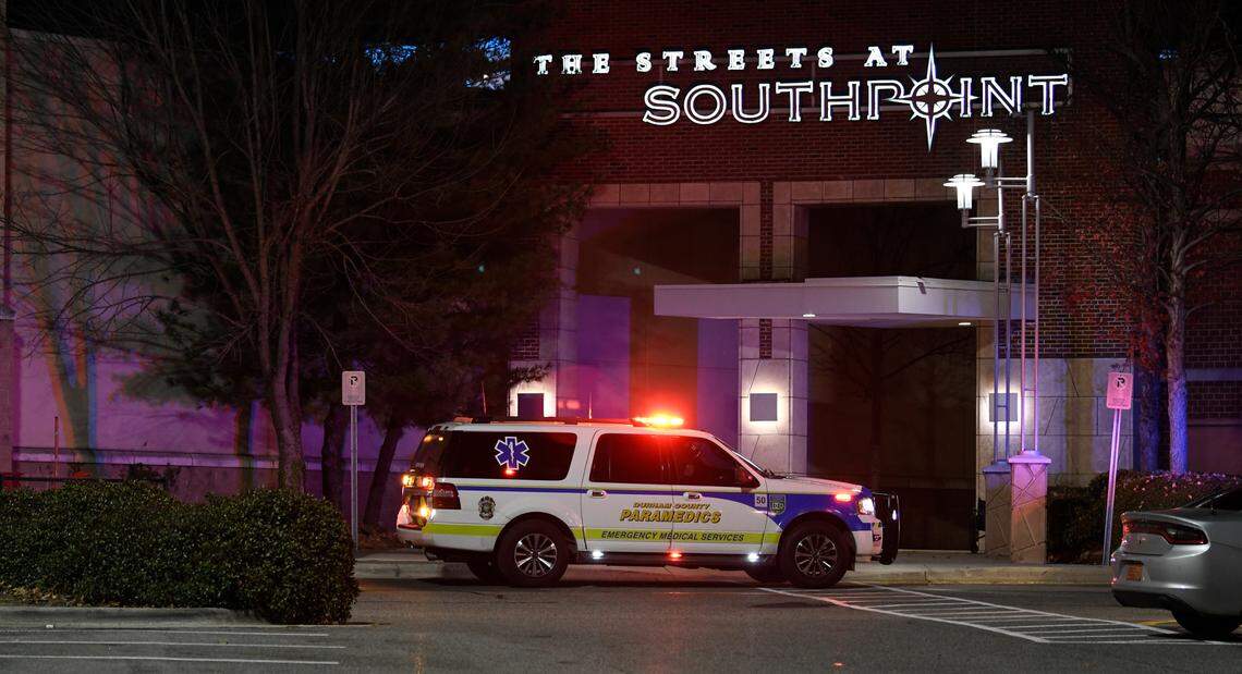 A paramedic vehicle sits outside an upper level entrance to The Streets at Southpoint mall in Durham, N.C. after a shooting left three people wounded, Friday, Nov. 26, 2021.
