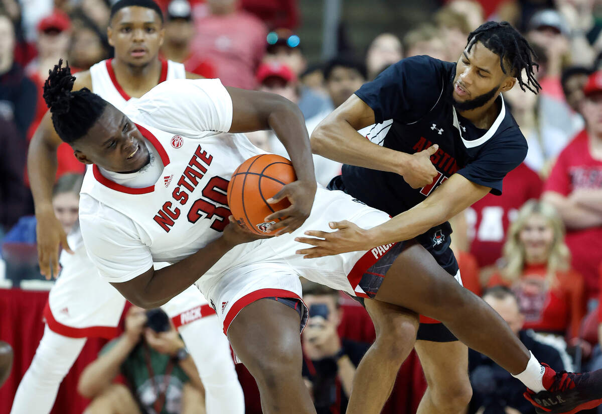 N.C. State’s D.J. Burns Jr. (30) rips the rebound from Austin Peay’s Shon Robinson (12) during the first half of N.C. State’s season opening game against Austin Peay at PNC Arena in Raleigh, N.C., Monday, Nov. 7, 2022.