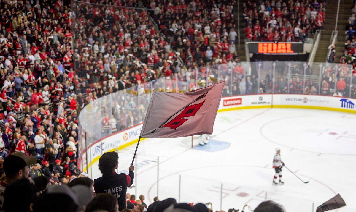 Carolina Hurricanes fans celebrate following Brady Skjei’s game winning goal in the third period against Ottawa on Wednesday, October 11, 2023 at PNC Arena, in Raleigh N.C.