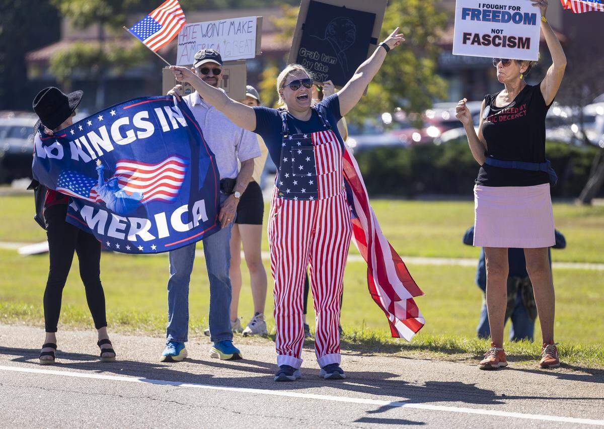 Adrian Raley, of Raleigh, N.C.waves her flag during the ‘No Kings’ protest along Capital Blvd. on Saturday, October 18, 2025 in Raleigh, N.C. 