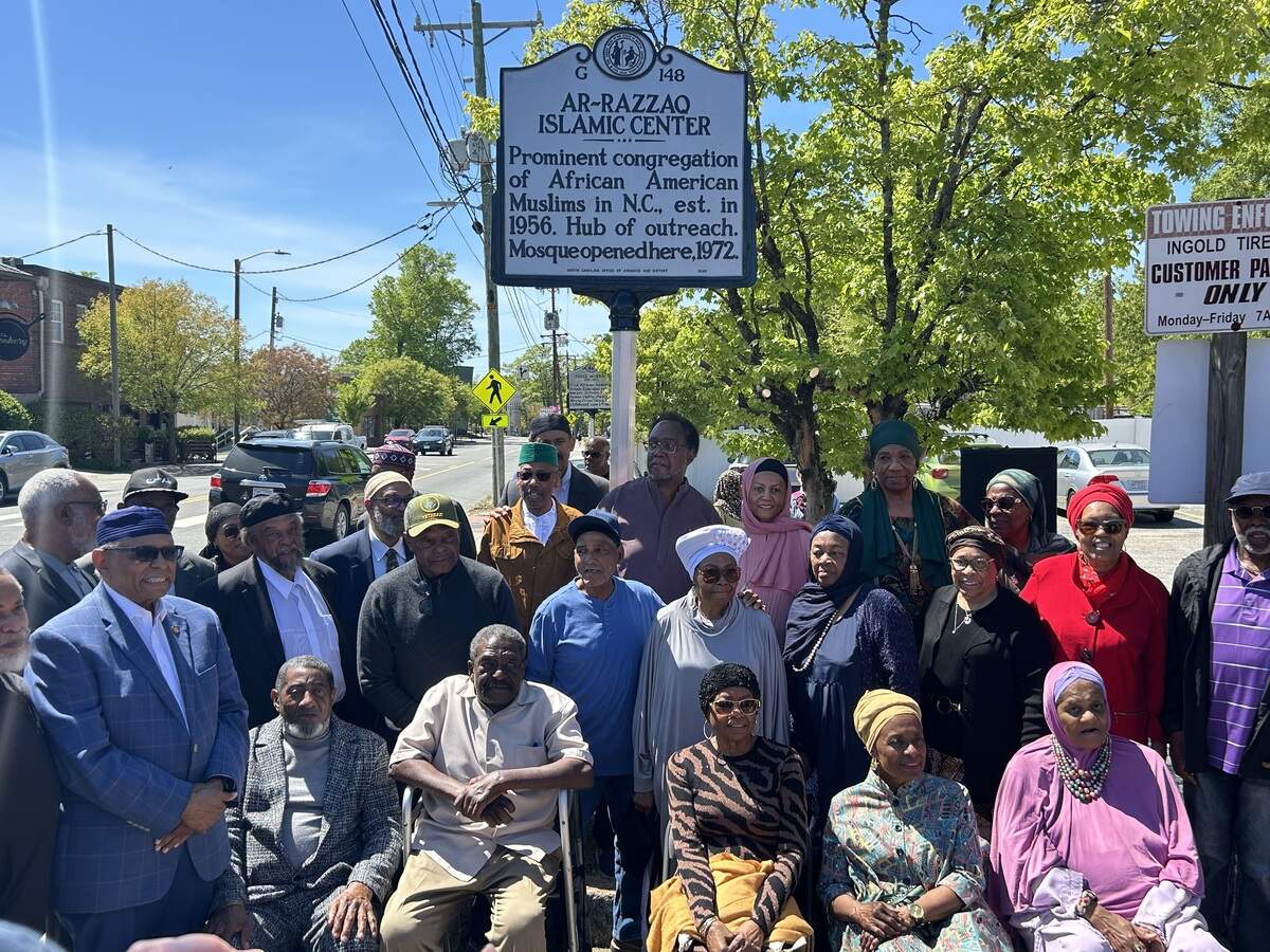 Pioneering members of Ar-Razzaq Islamic Center, the first mosque in North Carolina, stand by the NC marker erected in its honor Friday on West Chapel Hill Street in Durham.