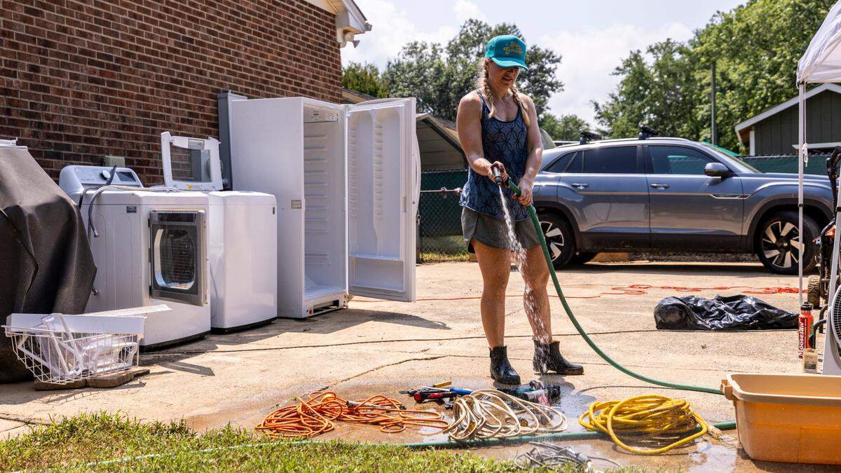 Heather Jacobson begins the process of sorting, washing and salvaging belongings at her home in Durham’s Old Farm neighborhood near the Eno River on Wednesday, July 9, 2025, after flash flooding caused by Tropical Storm Chantal.