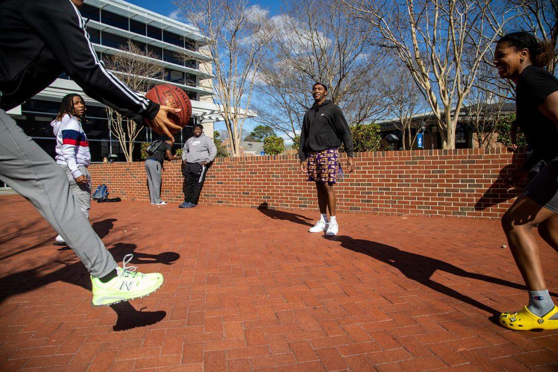 A group of Elizabeth City State University students play a game of “taps” outside the Walter N. and Henrietta B. Ridley Student Complex Tuesday, March 1, 2022.