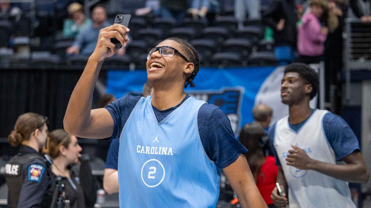 North Carolina forward James Brown (2) records his entrance to the University of Dayton Arena as the Tar Heels take the court for their practice ahead of the First Four game against San Diego State in the NCAA Tournament on Monday, March 17, 2025 in Dayton, Ohio.