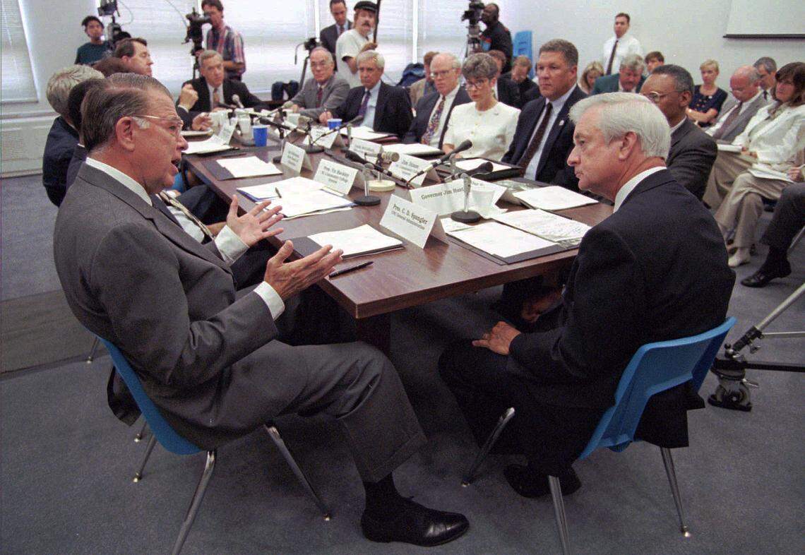 C.D. Spangler, UNC president, left, tells Gov. Jim Hunt, right, that he has never appreciated quitters and is unlikely to start, during the education cabinet meeting held in Raleigh, N.C., Tuesday, June. 25, 1996. Spangler was referring to members of the General Assembly who adjourned last Saturday without reaching agreement on the state budget. 