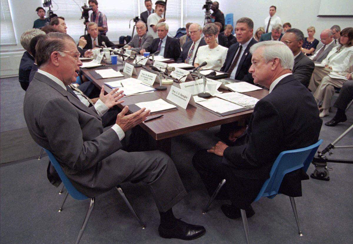 C.D. Spangler, UNC president, left, tells Gov. Jim Hunt, right, that he has never appreciated quitters and is unlikely to start, during the education cabinet meeting held in Raleigh, N.C., Tuesday, June. 25, 1996. Spangler was referring to members of the General Assembly who adjourned last Saturday without reaching agreement on the state budget. 