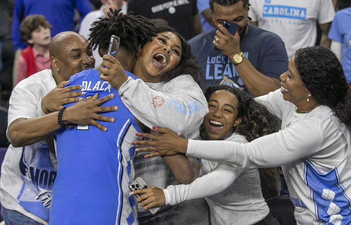 North Carolinas Leaky Black (1) is embraces by his family following the Tar Heels 81-77 victory over Duke during the NCAA Final Four semi-final on Saturday, April 2, 2022 at Caesars Superdome in New Orleans, La.