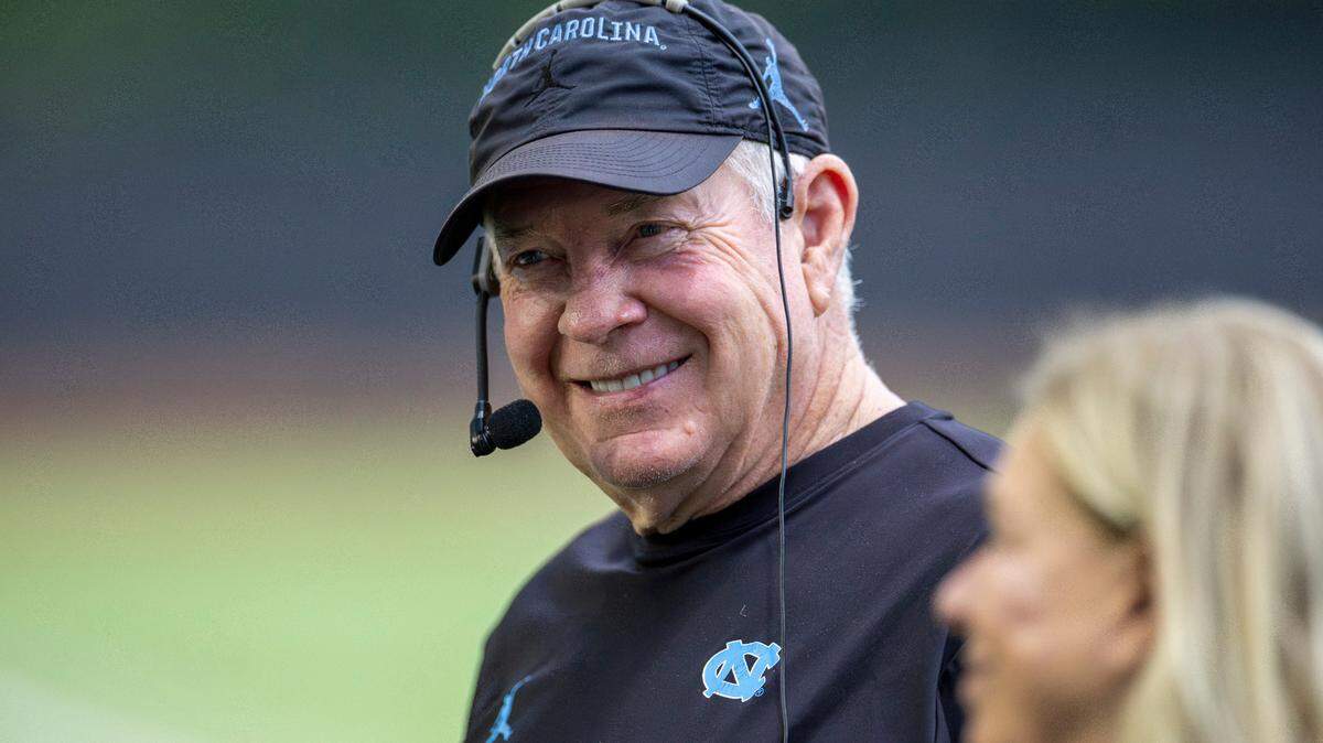 North Carolina coach Mack Brown talks with his wife Sally during the Tar Heels’ first practice of the season on Monday, July 29, 2024 in Chapel Hill, N.C.