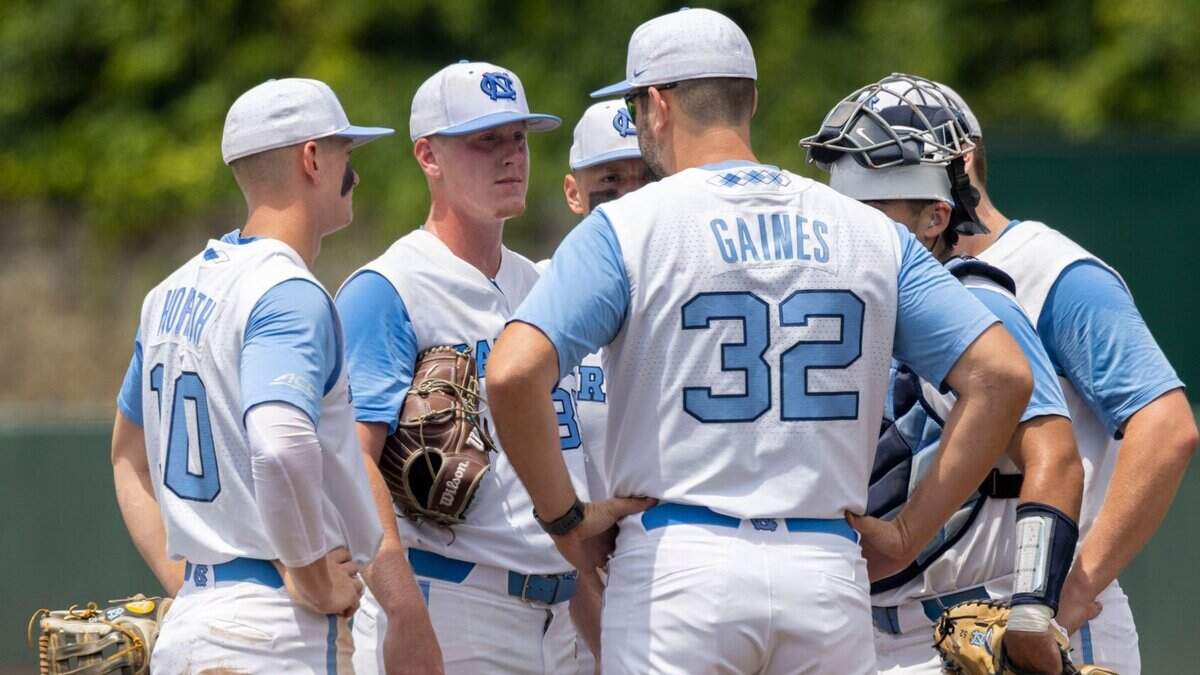 North Carolina coach Bryant Gaines confers with North Carolina starting pitcher Max Carlson (35) in the fifth inning against Arkansas during the first game of their Super Regional series on Saturday, June 11, 2022 at Boshamer Stadium in Chapel Hill, N.C.
