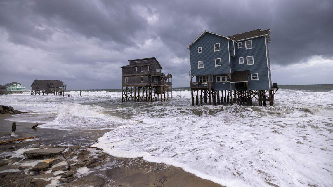Rough surf threatens beach homes during high tide Friday morning, Oct. 10, 2025, in Buxton as a storm approaches the North Carolina coast. Nine homes in the community have collapsed into the Atlantic Ocean since mid-September.
